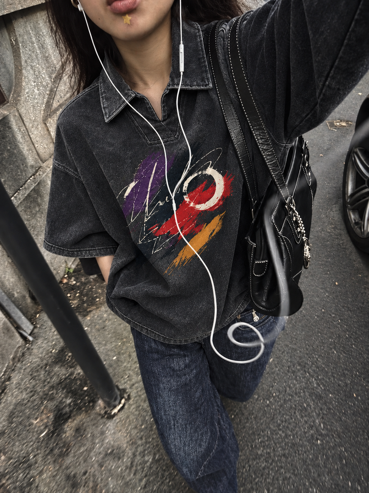 Street selfie in a washed black denim polo with a painted crescent print